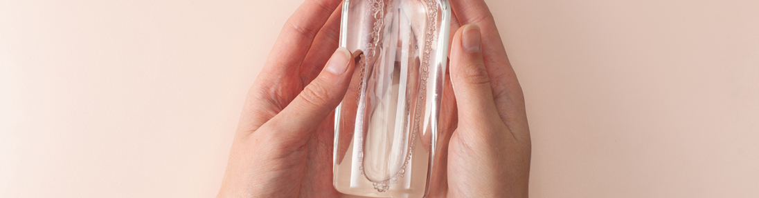 Bottle with micellar cleansing water in women's hands