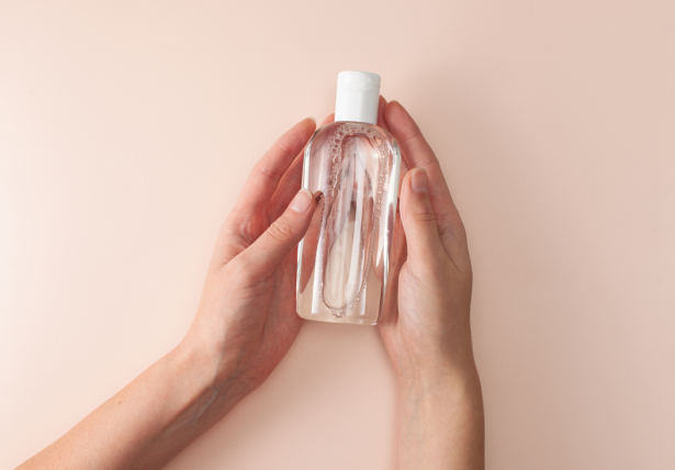 Bottle with micellar cleansing water in women's hands
